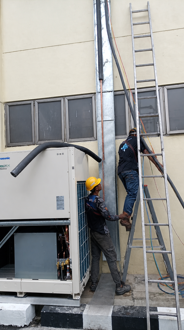 Two technicians installing aircond photo